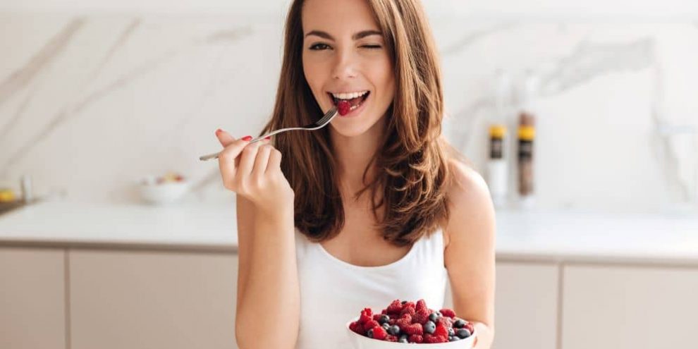 Woman eating berries.