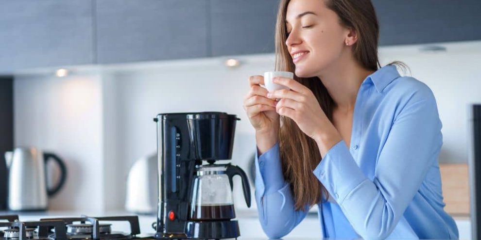 Woman drinking freshly brewed coffee