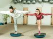 Couple balancing on Bosu balls.