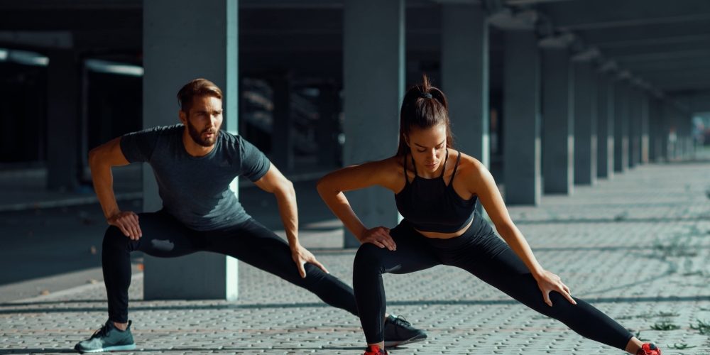 Couple stretching before work out.