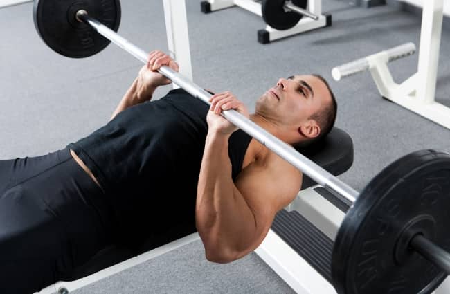 The bench press is a great exercise to work your chest and core. But a change in grip can help expand your arms.